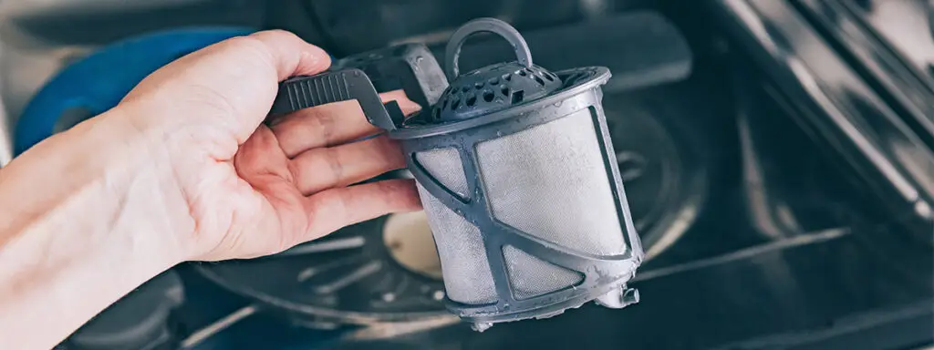 Five Dishwasher Faults That Are Almost Always The Filter 2 Dishwasher Filter Lifted Out Of The Base Of The Machine For Cleaning